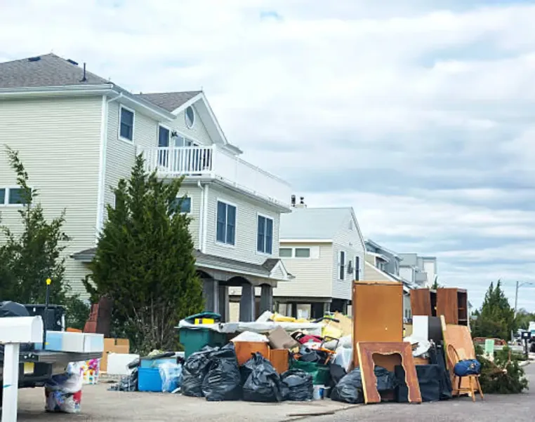 Bagged and boxed household junk stacked at the kerb outside New Jersey homes